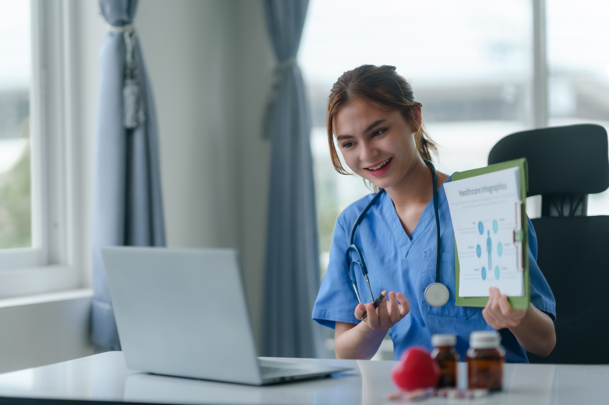 Remote Medical Office 5 Doctor or nurse consulting with patient online using laptop computer in hospital.